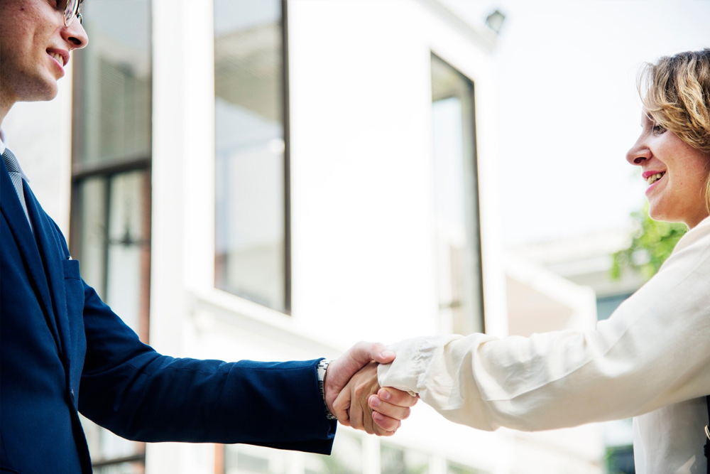 successful-female-business-professional-meeting-with-customers-shaking-hands_74855-10411